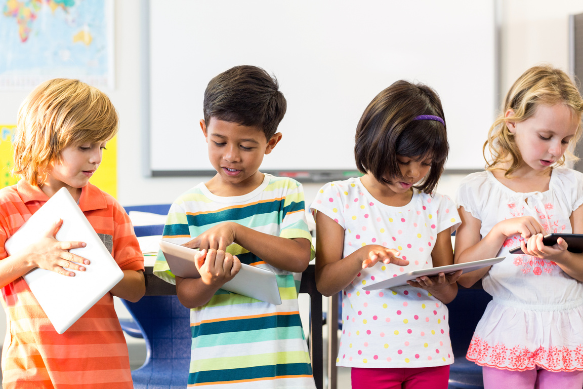 School kids using digital tablets